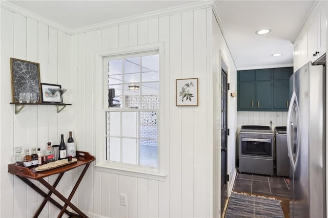 entryway with ornamental molding, a wealth of natural light, and washing machine and clothes dryer