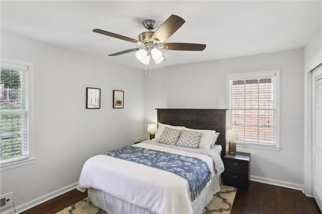 bedroom with dark hardwood / wood-style floors and ceiling fan