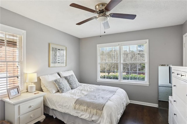 bedroom with ceiling fan and dark hardwood / wood-style flooring