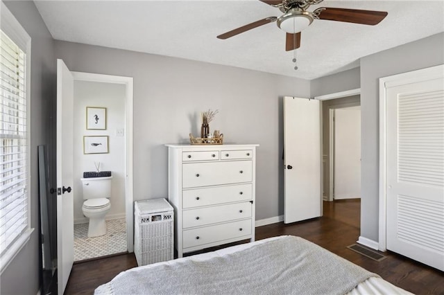 bedroom with ceiling fan, connected bathroom, and dark hardwood / wood-style flooring