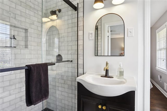 bathroom featuring vanity, a shower with shower door, and wood-type flooring