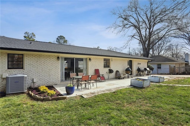 rear view of property with a patio area, central AC unit, and a lawn