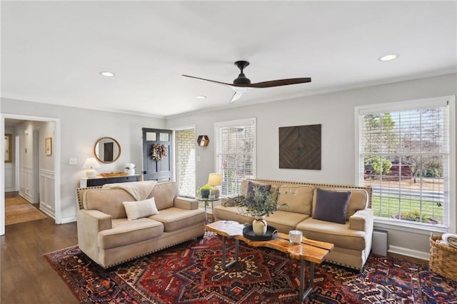 living room with crown molding, dark hardwood / wood-style floors, and ceiling fan