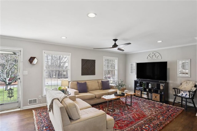 living room featuring crown molding, dark wood-type flooring, and ceiling fan