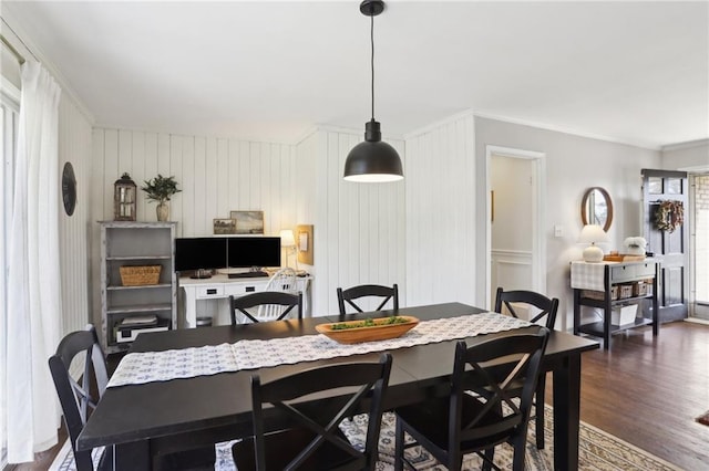 dining area with dark hardwood / wood-style flooring and ornamental molding