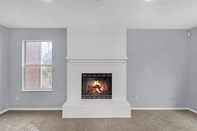 unfurnished living room with a brick fireplace and carpet floors