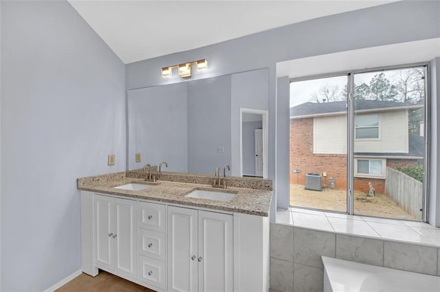 bathroom with vanity and a tub