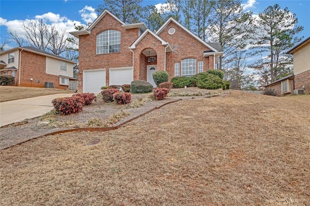 view of front property with a garage, central AC unit, and a front lawn