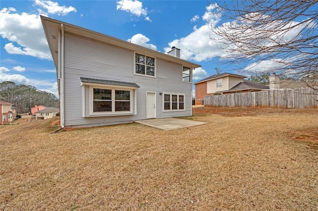 back of property with a yard and a patio area