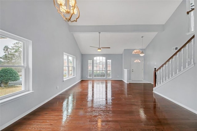 entryway with dark hardwood / wood-style flooring, a notable chandelier, and high vaulted ceiling