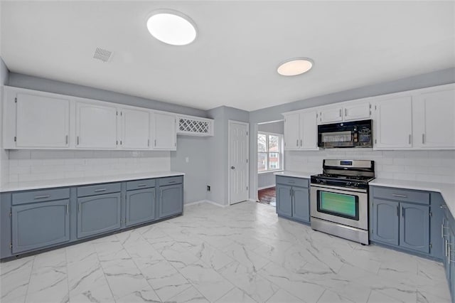 kitchen featuring white cabinetry, blue cabinetry, gas stove, and decorative backsplash