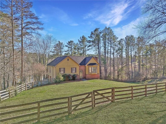 exterior space with a fenced front yard and a front lawn