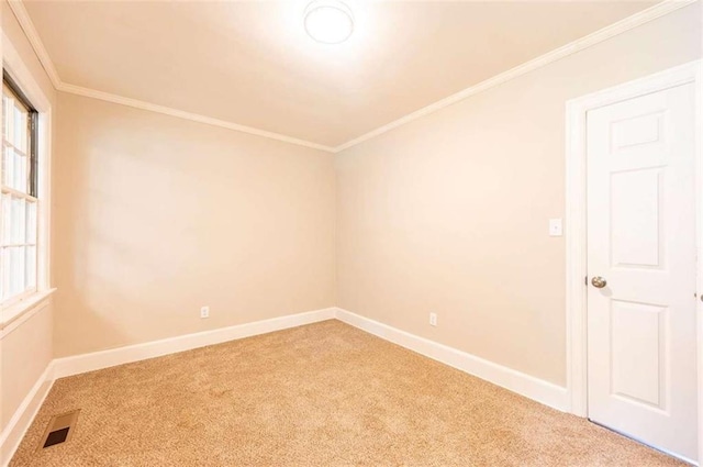 carpeted spare room with crown molding