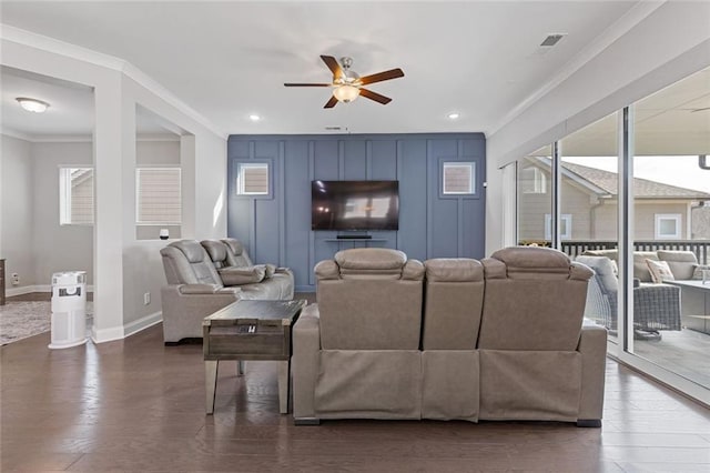 living area featuring ornamental molding, visible vents, dark wood finished floors, and baseboards