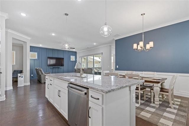 kitchen featuring crown molding, a decorative wall, stainless steel dishwasher, a sink, and ceiling fan with notable chandelier