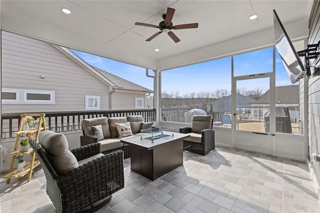 sunroom featuring ceiling fan