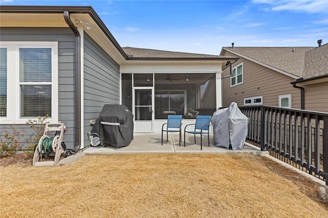 rear view of house with a sunroom, a yard, and a patio