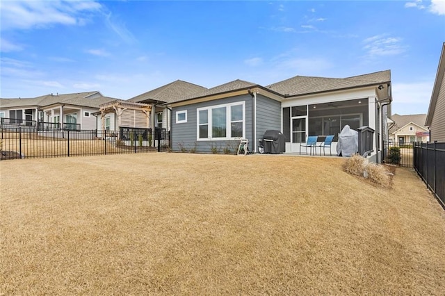 rear view of property with a patio area, a sunroom, a fenced backyard, and a pergola