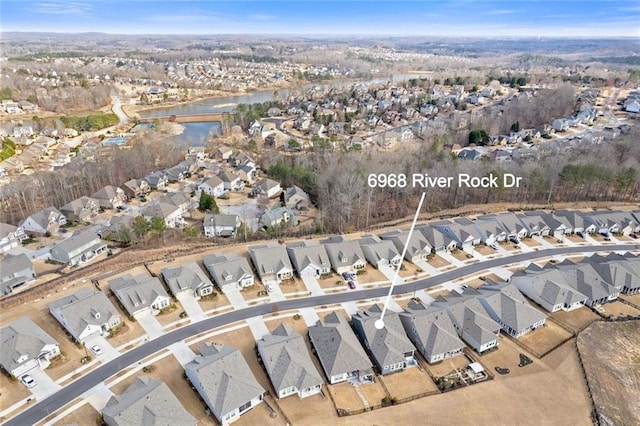 drone / aerial view with a residential view and a water view