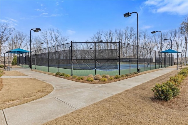 view of sport court featuring fence