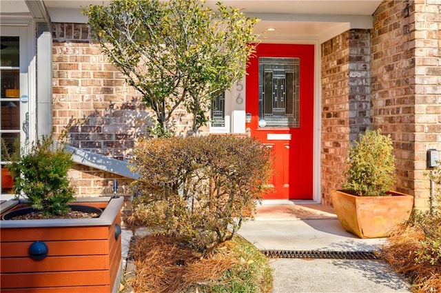 entrance to property featuring brick siding