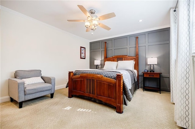 bedroom with baseboards, ornamental molding, a decorative wall, and light colored carpet