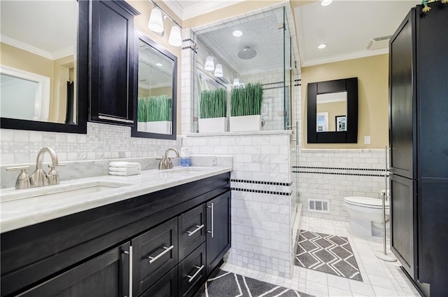 bathroom with a sink, tile walls, and crown molding