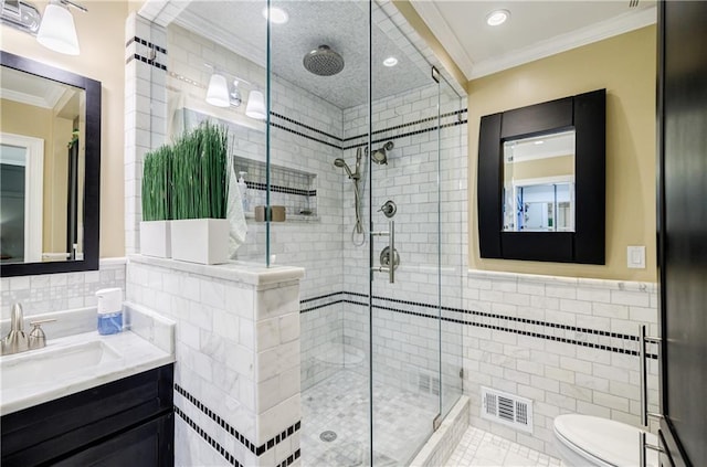 bathroom with toilet, visible vents, tile walls, ornamental molding, and a stall shower