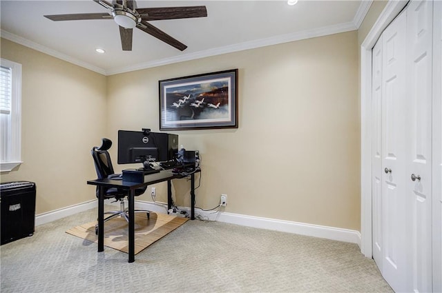 carpeted home office with ceiling fan, baseboards, and crown molding