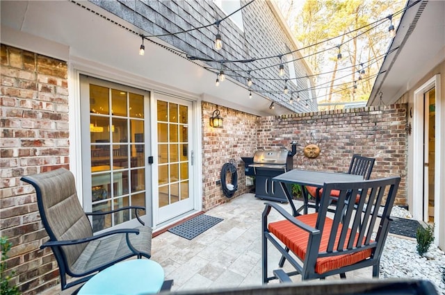 view of patio with outdoor dining area and grilling area