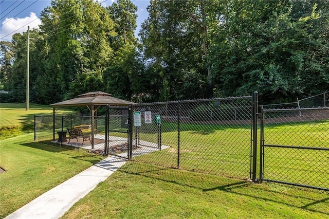 view of home's community featuring a gazebo, a lawn, fence, and a gate