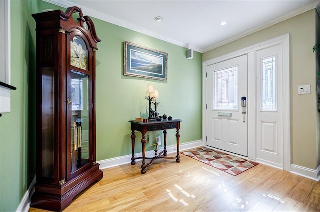 entrance foyer featuring recessed lighting, crown molding, baseboards, and wood finished floors