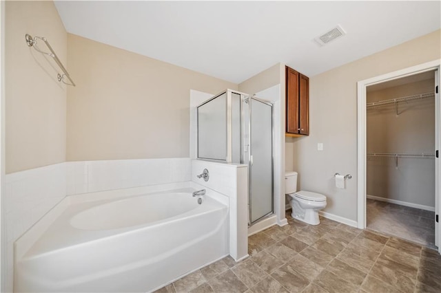 bathroom with visible vents, toilet, a shower stall, a bath, and a spacious closet