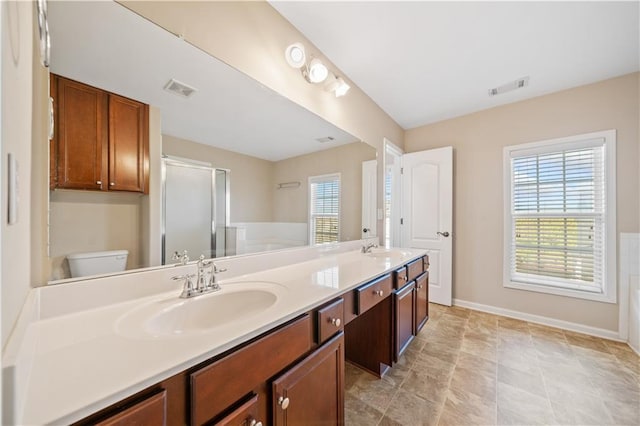 full bath featuring double vanity, visible vents, and a sink