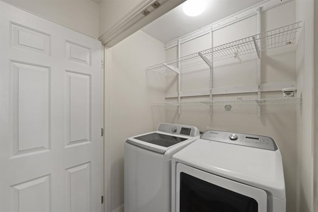 washroom with laundry area and washer and dryer