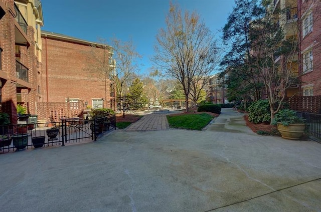 view of community with a patio area and fence