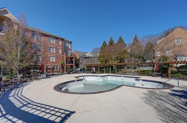 view of pool featuring a patio area, fence, and a jacuzzi