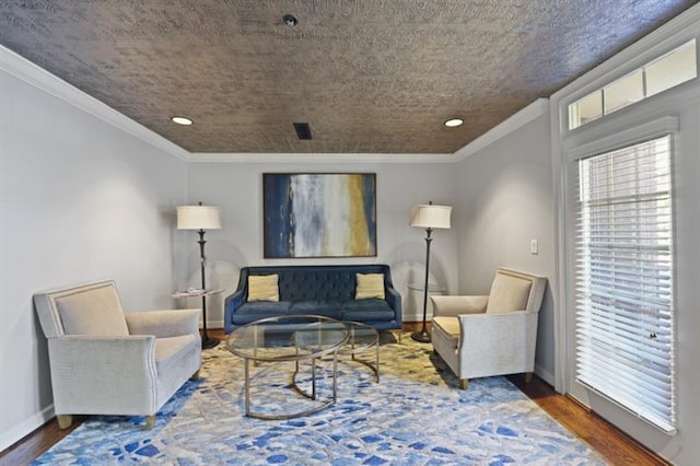 living room with crown molding, baseboards, and wood finished floors