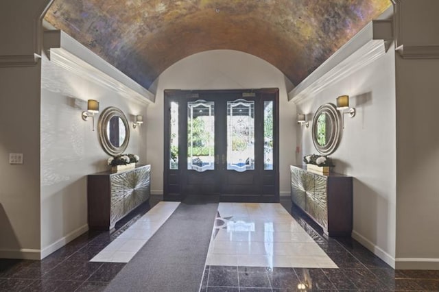 entrance foyer featuring granite finish floor, baseboards, and vaulted ceiling