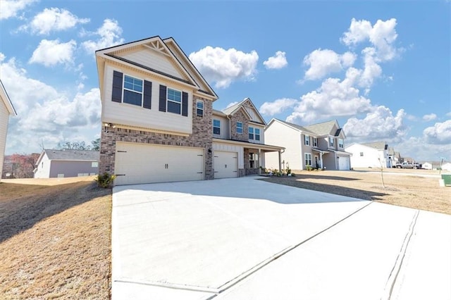 view of front facade with an attached garage, driveway, a residential view, and brick siding