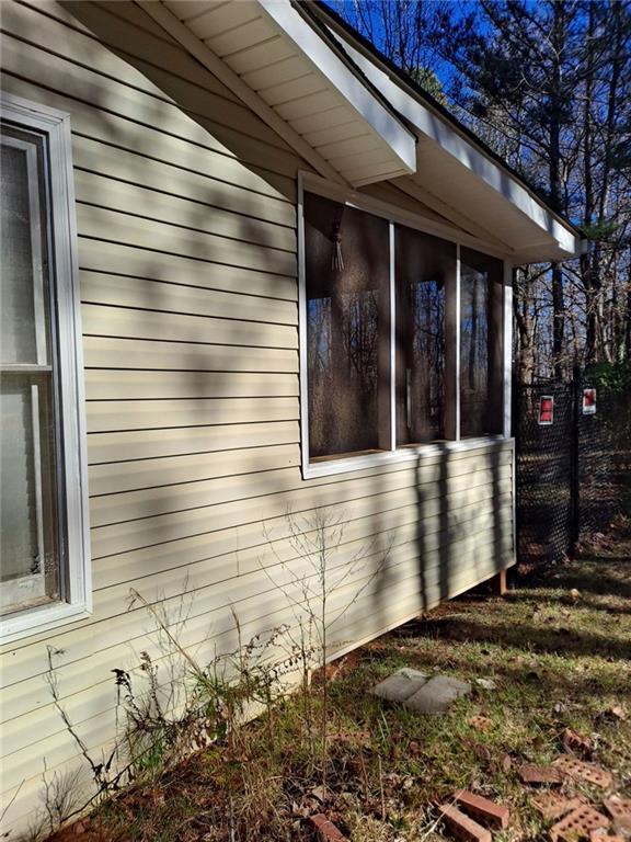 view of side of home with a sunroom