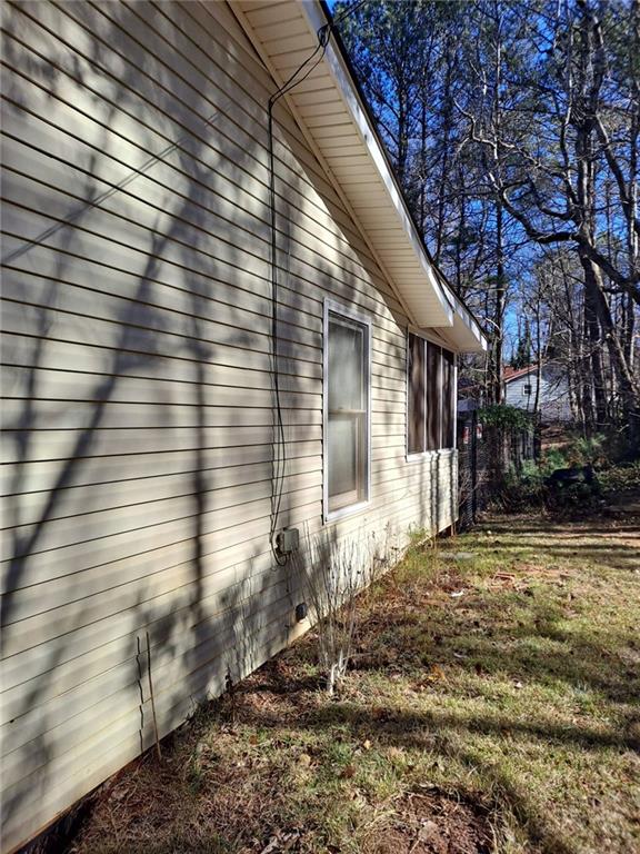 view of side of property with a lawn