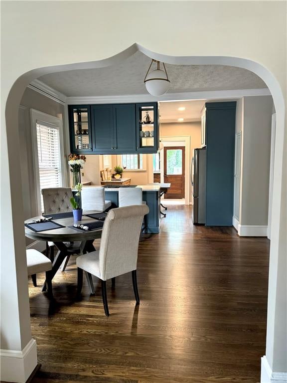 dining room featuring dark hardwood / wood-style floors and ornamental molding