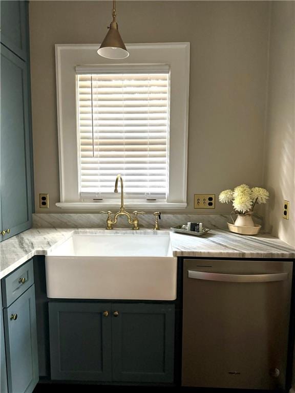 kitchen featuring a healthy amount of sunlight, pendant lighting, sink, and stainless steel dishwasher