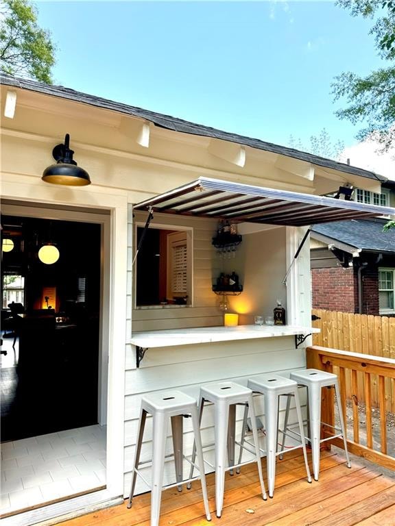 exterior space featuring hardwood / wood-style flooring and a kitchen breakfast bar