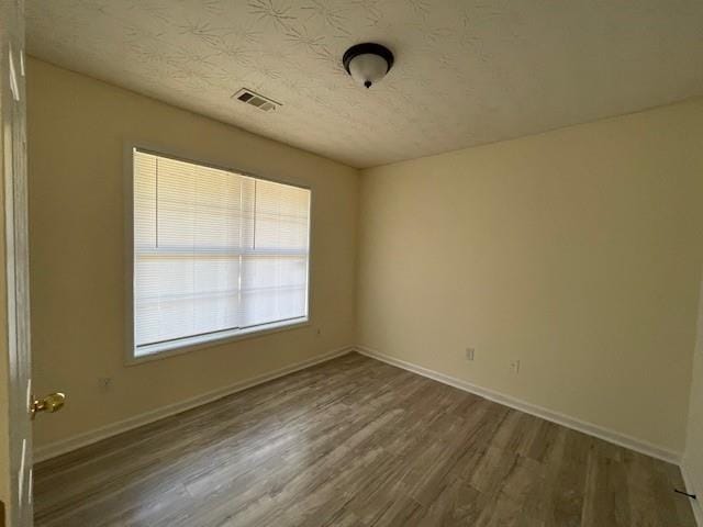 unfurnished room featuring dark hardwood / wood-style floors