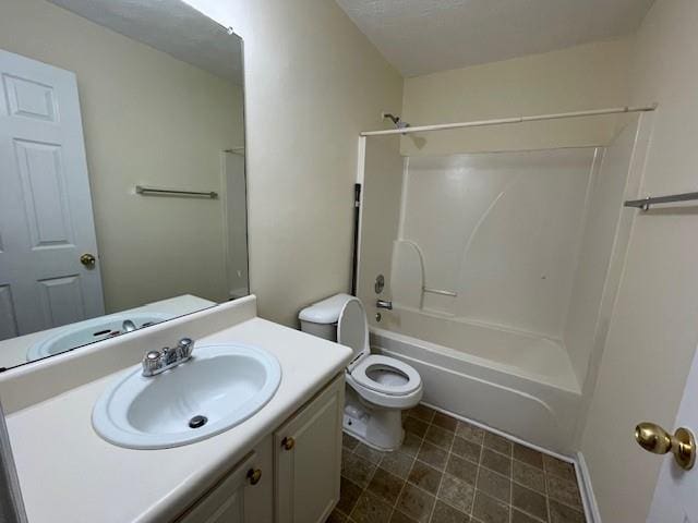 full bathroom featuring bathing tub / shower combination, vanity, a textured ceiling, and toilet