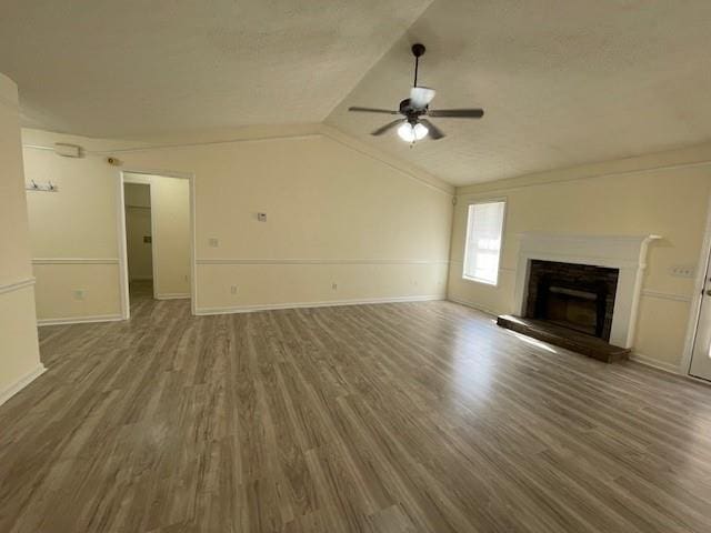 unfurnished living room featuring wood-type flooring, vaulted ceiling, ceiling fan, and ornamental molding