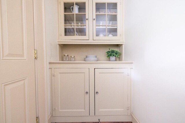 washroom with separate washer and dryer, cabinet space, and baseboards