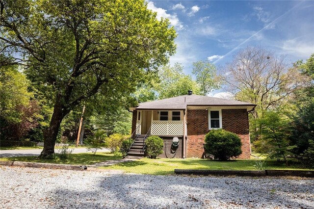 view of front of property with brick siding and a front lawn